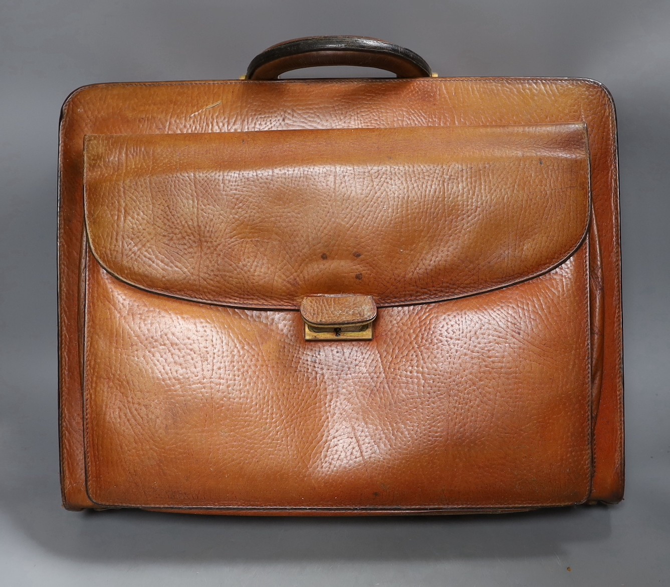 A vintage brown leather briefcase with integrated lock system, together with another Italian Giovanni briefcase